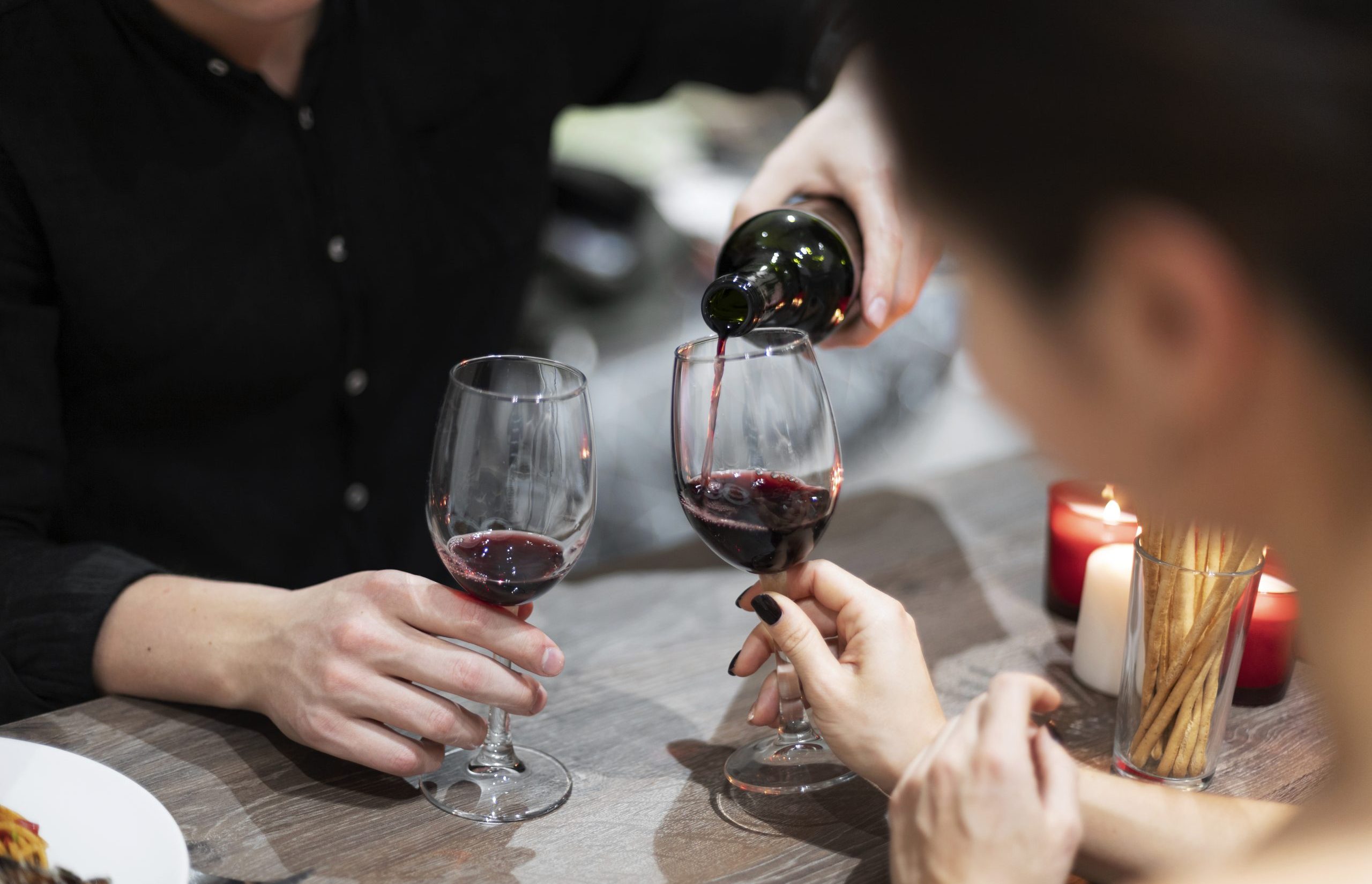 young-couple-celebrating-valentine-s-day-while-having-lunch-wine-together